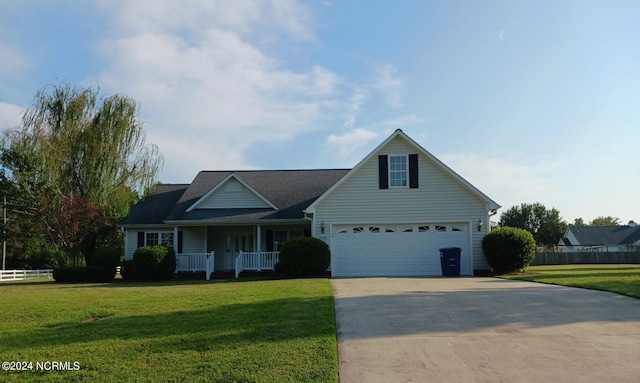 view of front of home featuring a front yard, a garage, and a porch