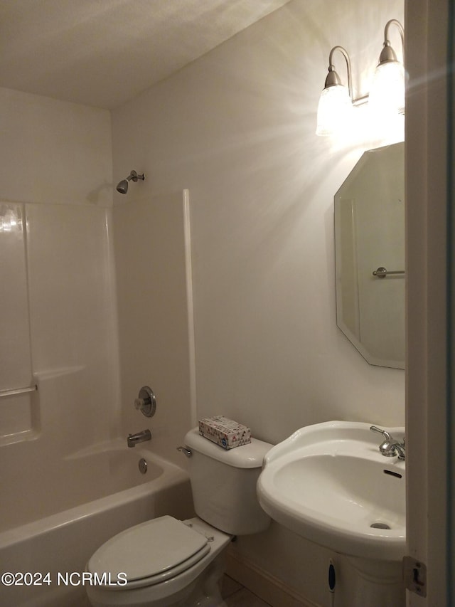 full bathroom with toilet, sink, and shower / washtub combination