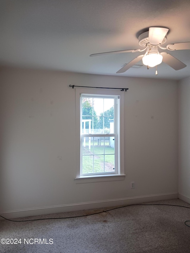 unfurnished room with a healthy amount of sunlight, ceiling fan, and carpet flooring