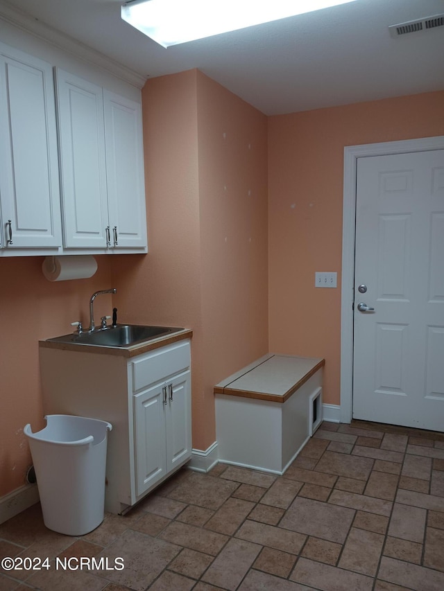 kitchen with sink and white cabinetry