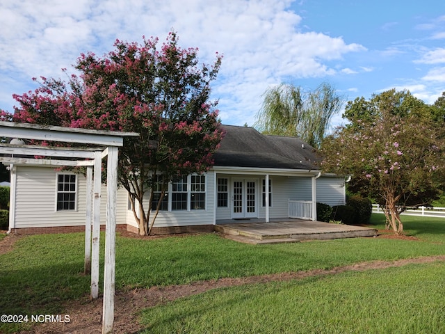 rear view of house featuring french doors, a pergola, a yard, and a patio