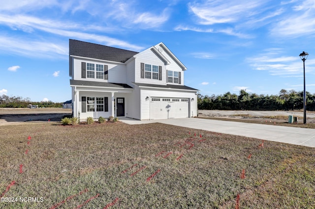 view of front of home with a front yard and a garage