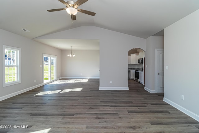 unfurnished living room featuring ceiling fan with notable chandelier, dark hardwood / wood-style floors, and lofted ceiling