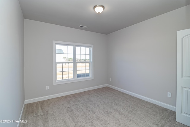 unfurnished room featuring light carpet