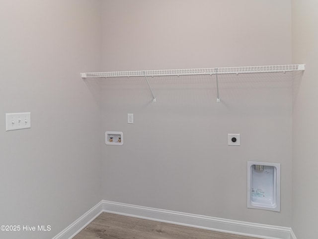 clothes washing area with hardwood / wood-style flooring, hookup for a washing machine, and hookup for an electric dryer