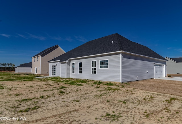 rear view of house with a garage