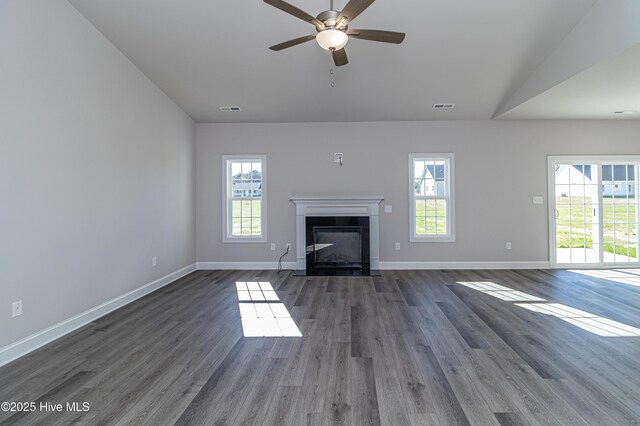 unfurnished living room featuring ceiling fan, lofted ceiling, and dark wood-type flooring