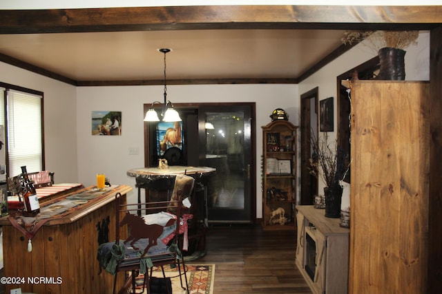 dining space featuring ornamental molding and dark wood-type flooring