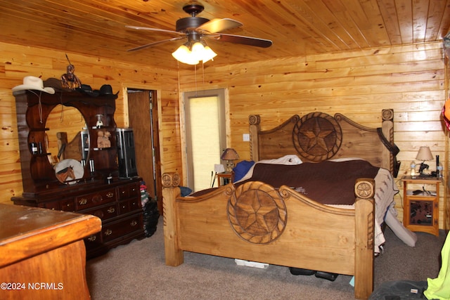 carpeted bedroom featuring wooden ceiling, ceiling fan, and wood walls