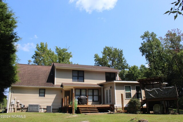 rear view of property with central AC, a lawn, a deck, and a pergola