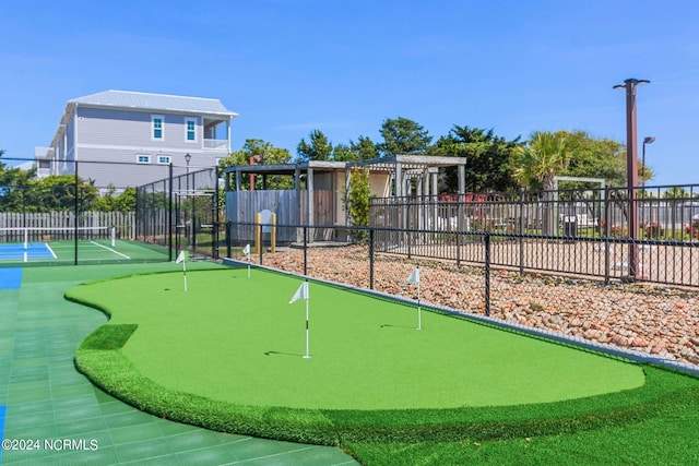 view of home's community featuring a tennis court, fence, and a pergola