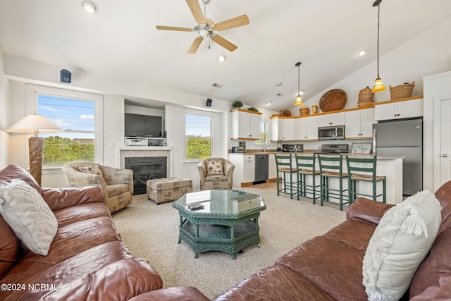 living room with recessed lighting, light colored carpet, a ceiling fan, and a tile fireplace