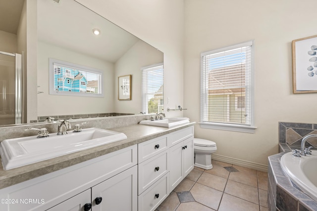 full bath featuring double vanity, a garden tub, tile patterned flooring, and a sink