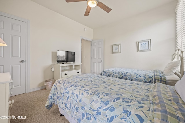 carpeted bedroom with a ceiling fan and baseboards