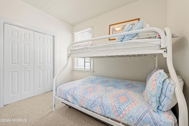 bedroom with carpet and a closet