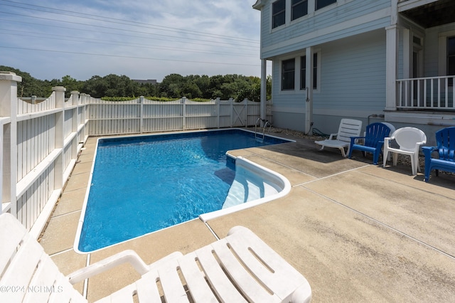 view of pool featuring a patio, a fenced backyard, and a fenced in pool