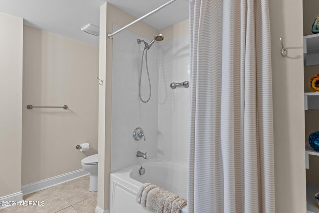 bathroom featuring toilet, tile patterned flooring, and shower / bathtub combination with curtain