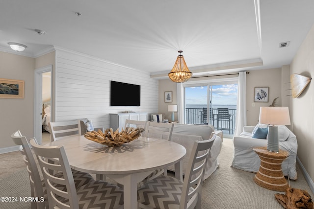 dining room featuring baseboards, a notable chandelier, visible vents, and crown molding