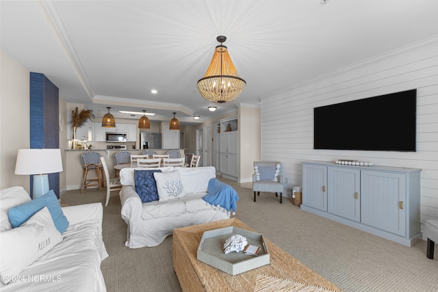 living area featuring baseboards, crown molding, and light colored carpet