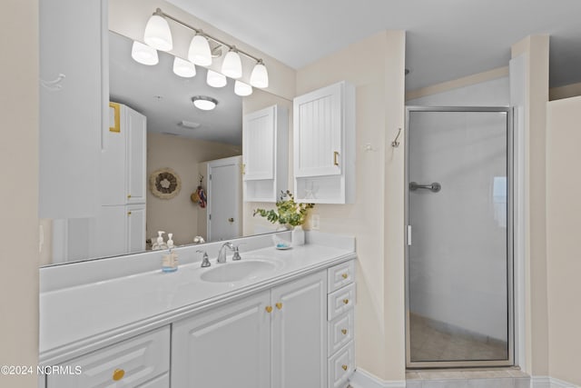 bathroom featuring tile patterned flooring, vanity, and walk in shower