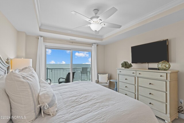 bedroom featuring a tray ceiling, ornamental molding, access to outside, and ceiling fan