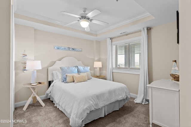 bedroom with carpet floors, baseboards, a tray ceiling, and ornamental molding