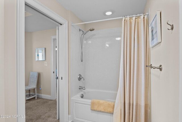 bathroom featuring shower / bath combo with shower curtain and baseboards