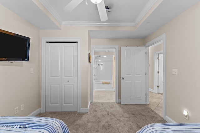 bedroom featuring carpet floors, baseboards, ornamental molding, and a closet