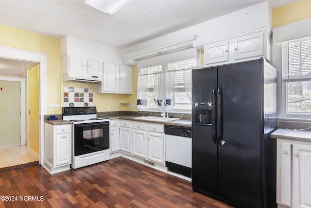 kitchen with white cabinetry, sink, plenty of natural light, dark hardwood / wood-style flooring, and white appliances