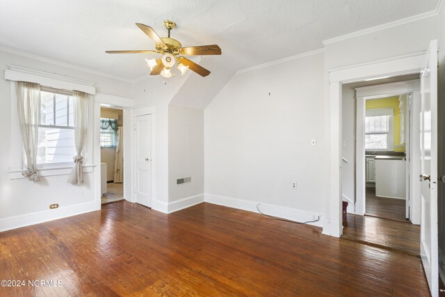 spare room featuring ceiling fan, a textured ceiling, dark hardwood / wood-style floors, and ornamental molding