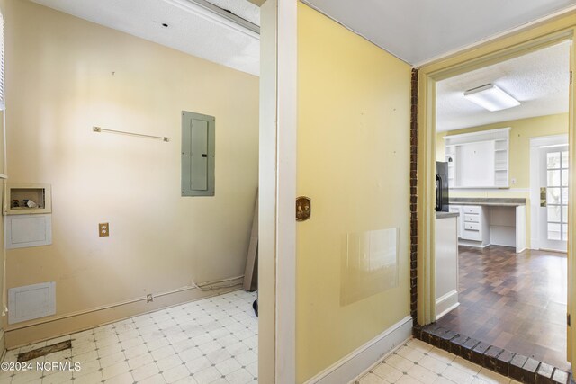 bathroom featuring a textured ceiling, tile patterned flooring, and electric panel