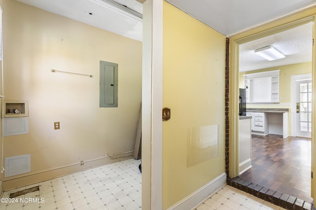 bathroom with baseboards, electric panel, and tile patterned floors