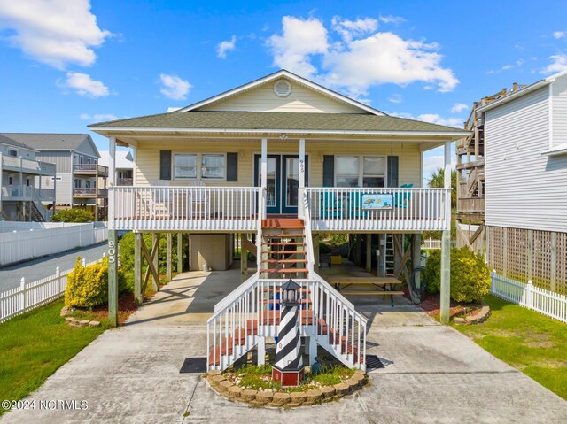 view of front of house with a carport and a porch