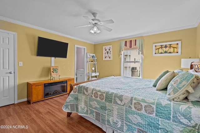 bedroom featuring crown molding, wood-type flooring, and ceiling fan