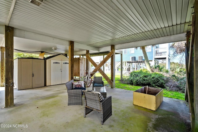 view of patio featuring a storage shed and an outbuilding