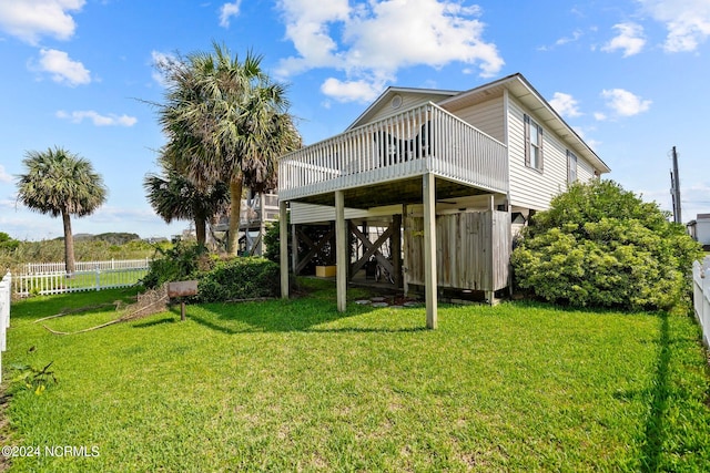 rear view of house featuring a yard, stairway, fence, and a wooden deck