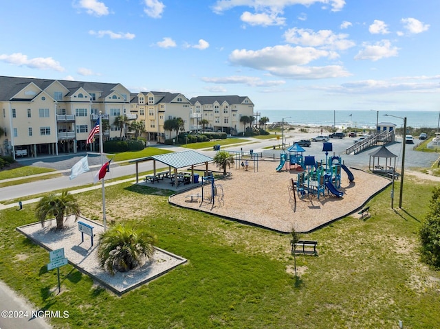 surrounding community featuring a yard, a water view, and a playground