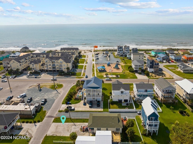 birds eye view of property featuring a beach view and a water view