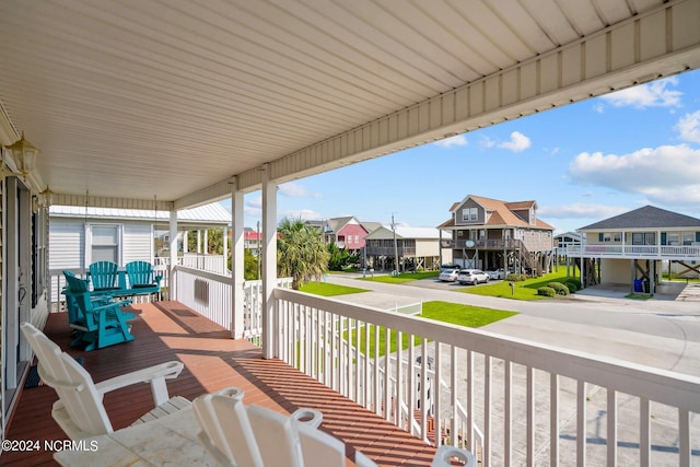 deck featuring a porch and a residential view