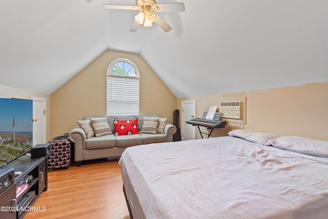 bedroom with ceiling fan, light hardwood / wood-style flooring, lofted ceiling, and a wall unit AC