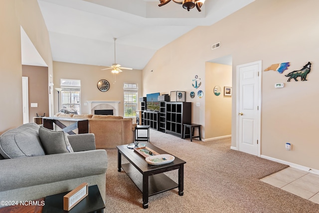 living room with ceiling fan, a fireplace, carpet flooring, and high vaulted ceiling