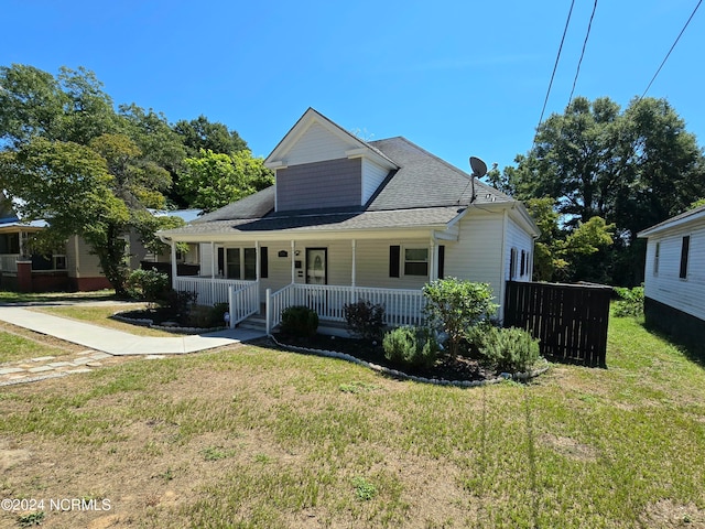 view of front of house with covered porch and a front yard