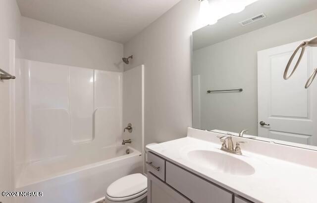 full bathroom with tub / shower combination, toilet, and vanity