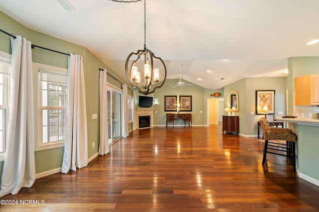 dining room with lofted ceiling, dark hardwood / wood-style floors, and ceiling fan with notable chandelier