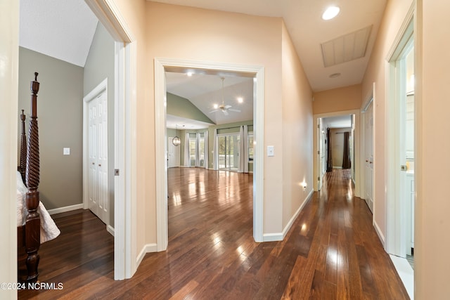 hall featuring dark hardwood / wood-style flooring and lofted ceiling