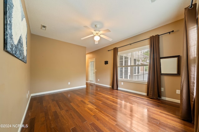 unfurnished room with ceiling fan and hardwood / wood-style floors