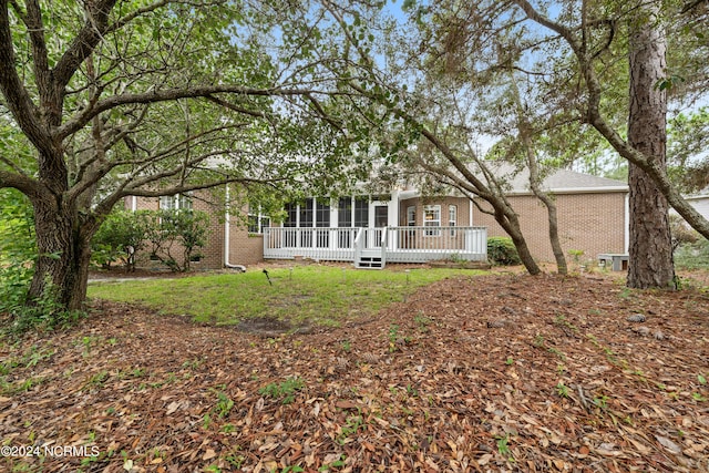 back of property featuring a wooden deck