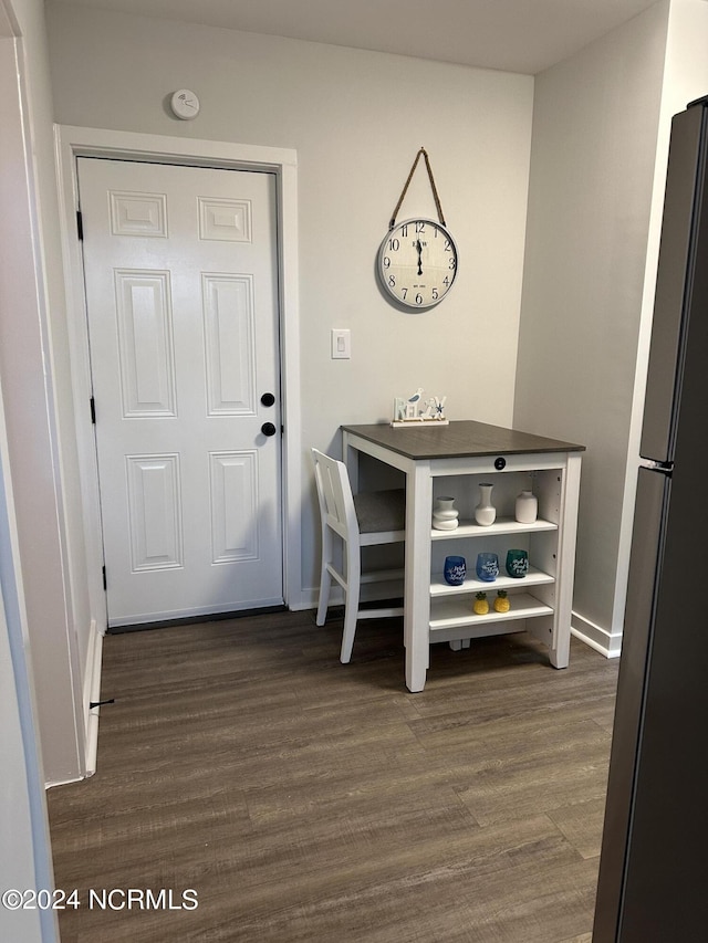 interior space featuring dark wood-type flooring and baseboards