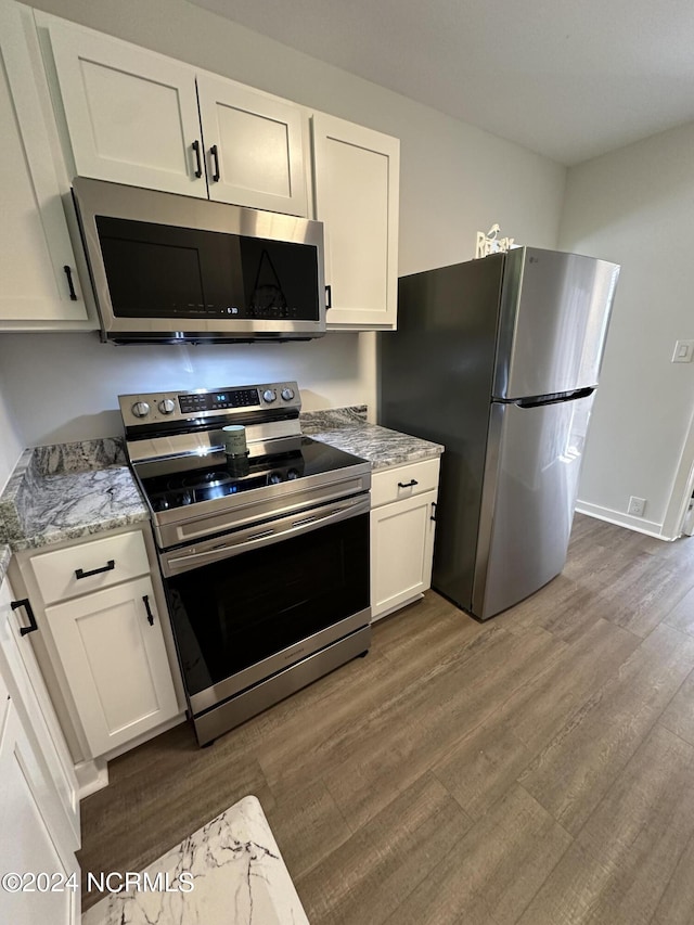 kitchen featuring white cabinets, stainless steel appliances, and dark wood-style flooring