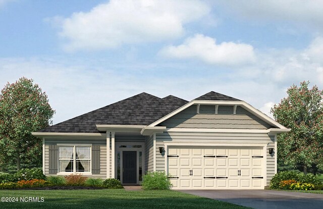 view of front of home with a garage and a front yard